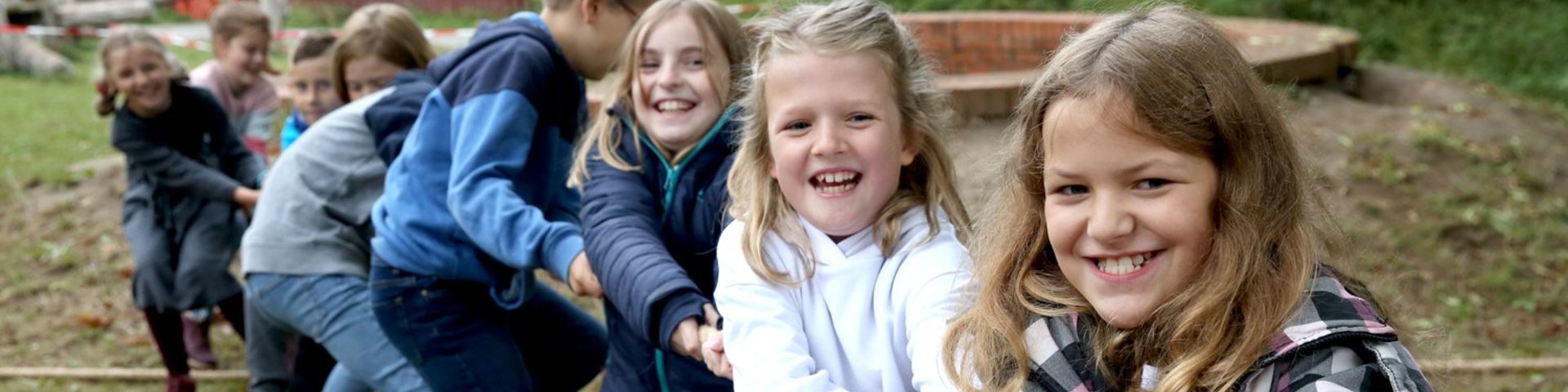 Fröhliche Kinder beim Tauziehen